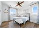 Bedroom with a large window with mountain views and neutral décor with hardwood floors at 1601 Mariah Ln, Erie, CO 80516