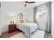 Cozy bedroom with a ceiling fan, warm color scheme, and soft natural light from the large window at 1601 Mariah Ln, Erie, CO 80516