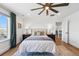 Large bedroom with a ceiling fan, hardwood floors, and plush bed, offering a comfortable retreat at 1601 Mariah Ln, Erie, CO 80516