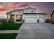 Exterior view of a two-story home with a three-car garage, manicured lawn, and welcoming curb appeal at 1601 Mariah Ln, Erie, CO 80516