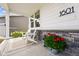 Charming front porch features stone accents, white siding, and a cozy seating area with seasonal decor at 1601 Mariah Ln, Erie, CO 80516