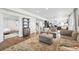 Spacious living room with hardwood floors, modern furniture, and an open layout at 1601 Mariah Ln, Erie, CO 80516