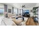 Comfortable living room with large tv, ceiling fan, and natural light at 1601 Mariah Ln, Erie, CO 80516