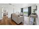 Bright living room featuring a view, hardwood floors, stylish décor, and comfortable seating area at 1601 Mariah Ln, Erie, CO 80516