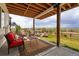 Cozy covered patio showcases an outdoor lounge area with scenic views and lush landscaping at 1601 Mariah Ln, Erie, CO 80516