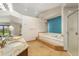 Luxurious bathroom with double vanity, soaking tub, tile flooring, and a modern accent wall at 15132 Pecos St, Broomfield, CO 80023