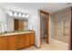 Bathroom features a double vanity with granite countertops and a shower-tub combo at 15132 Pecos St, Broomfield, CO 80023