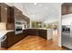 Spacious kitchen with sleek cabinetry, stainless steel appliances, and an adjacent living area at 15132 Pecos St, Broomfield, CO 80023