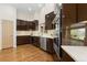 Modern kitchen with dark cabinetry, stainless steel appliances, and a window above the sink at 15132 Pecos St, Broomfield, CO 80023