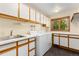Well-lit laundry room with ample storage, sink, washer, and dryer hookups at 15132 Pecos St, Broomfield, CO 80023