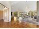 Bright living room with wood floors, large windows, and open layout to a kitchen at 15132 Pecos St, Broomfield, CO 80023