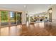 Bright living room featuring hardwood floors, vaulted ceiling, and sliding glass doors to outside at 15132 Pecos St, Broomfield, CO 80023