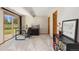 Bright office with a glass desk, sliding glass doors, and a bookcase with decor at 15132 Pecos St, Broomfield, CO 80023