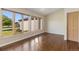 Sunlit room with hardwood floors and multiple windows offering views of the outdoors at 15132 Pecos St, Broomfield, CO 80023
