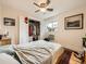 Comfortable bedroom with a ceiling fan, closet space, and a window with natural light at 2460 W Caithness Pl # 105, Denver, CO 80211