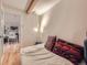 Bedroom with hardwood floors and exposed beam at 2460 W Caithness Pl # 105, Denver, CO 80211