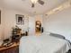 Bright bedroom with hardwood floors, featuring a view into the kitchen and cozy decor at 2460 W Caithness Pl # 105, Denver, CO 80211