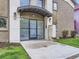 Close-up of apartment building entrance with covered canopy, secure doors, and mailboxes at 2460 W Caithness Pl # 105, Denver, CO 80211