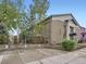 Side view of a two-story apartment building with dedicated parking and landscaping at 2460 W Caithness Pl # 105, Denver, CO 80211