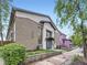 Exterior of a two-story apartment building with brick and stucco details with a landscaped entrance at 2460 W Caithness Pl # 105, Denver, CO 80211