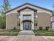 Two-story apartment building with brick and stucco, featuring a covered entrance and manicured landscaping at 2460 W Caithness Pl # 105, Denver, CO 80211