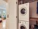 Efficient laundry area with stacked washer and dryer, maximizing space and convenience in this home at 2460 W Caithness Pl # 105, Denver, CO 80211