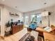 Bright living room featuring hardwood floors, eclectic decor, and a cozy seating area by the window at 2460 W Caithness Pl # 105, Denver, CO 80211