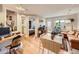 Open-concept living area with hardwood floors, featuring a dining table, desk, and bedroom views at 2460 W Caithness Pl # 105, Denver, CO 80211