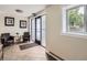 Apartment lobby featuring armchairs, artwork, tile flooring, and a frosted glass door at 2460 W Caithness Pl # 105, Denver, CO 80211