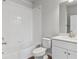 All-white bathroom featuring a tiled shower and modern vanity at 453 Interlocken Blvd # 101, Broomfield, CO 80021