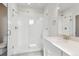 Modern bathroom with glass shower, white tiled walls, and a vanity with quartz countertop at 453 Interlocken Blvd # 101, Broomfield, CO 80021