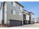 Stylish townhome exterior with a two-car garage, modern design, and appealing color palette, offering curb appeal at 453 Interlocken Blvd # 101, Broomfield, CO 80021
