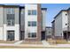 Modern townhome featuring mixed siding, brick accents, and low-maintenance landscaping at 453 Interlocken Blvd # 101, Broomfield, CO 80021