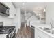 Open-concept kitchen with stainless steel appliances and bright white finishes at 453 Interlocken Blvd # 101, Broomfield, CO 80021