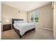 Comfortable bedroom features a large window with natural light and neutral wall-to-wall carpeting at 7212 S Blackhawk St # 1-103, Englewood, CO 80112