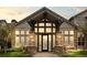 Elegant building entrance with stone pillars, ample windows, and craftsman style architectural elements at 7212 S Blackhawk St # 1-103, Englewood, CO 80112