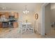 Cozy dining area with modern chandelier lighting, neutral colors, and a view into the kitchen at 7212 S Blackhawk St # 1-103, Englewood, CO 80112