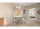 Cozy dining area with chandelier lighting, neutral colors, and view of the bedroom at 7212 S Blackhawk St # 1-103, Englewood, CO 80112