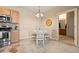 Cozy dining area with white table and chairs, opens to bathroom with a vanity at 7212 S Blackhawk St # 1-103, Englewood, CO 80112