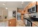 Bright kitchen features stainless steel appliances, granite countertops and island and convenient in-unit laundry at 7212 S Blackhawk St # 1-103, Englewood, CO 80112