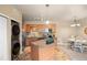 Eat in kitchen features stainless steel appliances, a center island, and laundry closet at 7212 S Blackhawk St # 1-103, Englewood, CO 80112