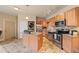 Well-appointed kitchen with stainless appliances, center island, and laundry closet at 7212 S Blackhawk St # 1-103, Englewood, CO 80112