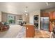 Open-concept living area features a fireplace, patio access, and flows seamlessly into the kitchen at 7212 S Blackhawk St # 1-103, Englewood, CO 80112