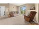 Carpeted living room with a fireplace, comfortable seating, and sliding glass doors at 7212 S Blackhawk St # 1-103, Englewood, CO 80112