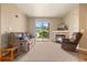 Cozy living room features a stone fireplace, plush seating, and a sliding door to the outside at 7212 S Blackhawk St # 1-103, Englewood, CO 80112