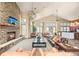 Spacious living room with a stone fireplace, soaring ceilings, and lots of natural light at 7212 S Blackhawk St # 1-103, Englewood, CO 80112