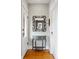 Inviting hallway with hardwood floors, a decorative mirror, and a charming console table at 1452 S Emerson St, Denver, CO 80210