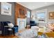 Bright living room featuring exposed brick, white mantle, hardwood floors, and stylish furniture and decor at 1452 S Emerson St, Denver, CO 80210