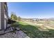 Backyard features a gentle slope, lush lawn and distant mountain views at 519 Wright St # 106, Lakewood, CO 80228