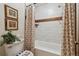 Bathroom with a modern bathtub, patterned shower curtain, and tiled walls, creating a clean and stylish space at 519 Wright St # 106, Lakewood, CO 80228